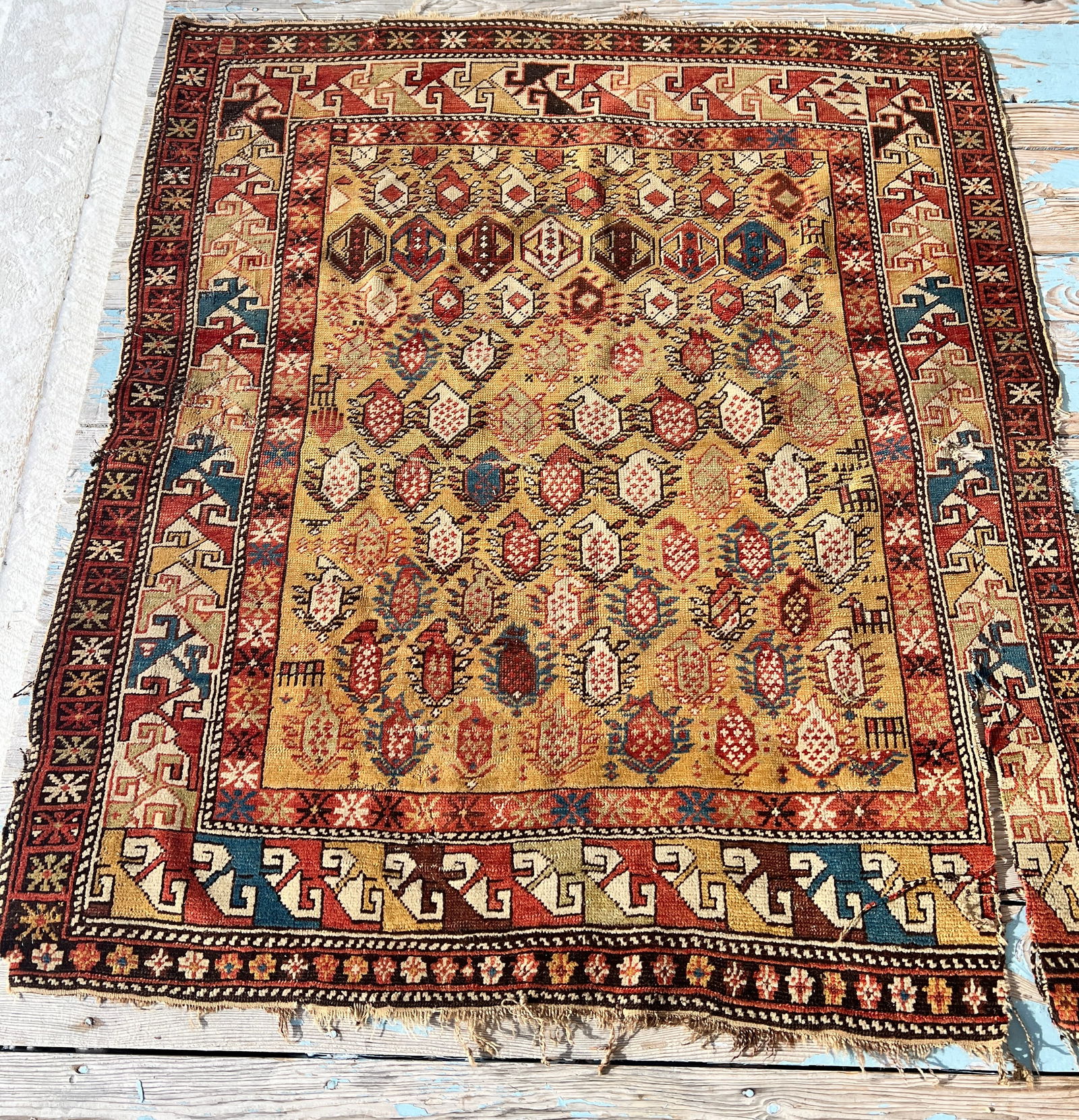 Antique Caucasian Kazak Oriental Rug: Approx 46 by 52 inches. As shown w/ some rips, losses, blemishes. What's to Love - Its already has rips and wear so don't have to worry about it.