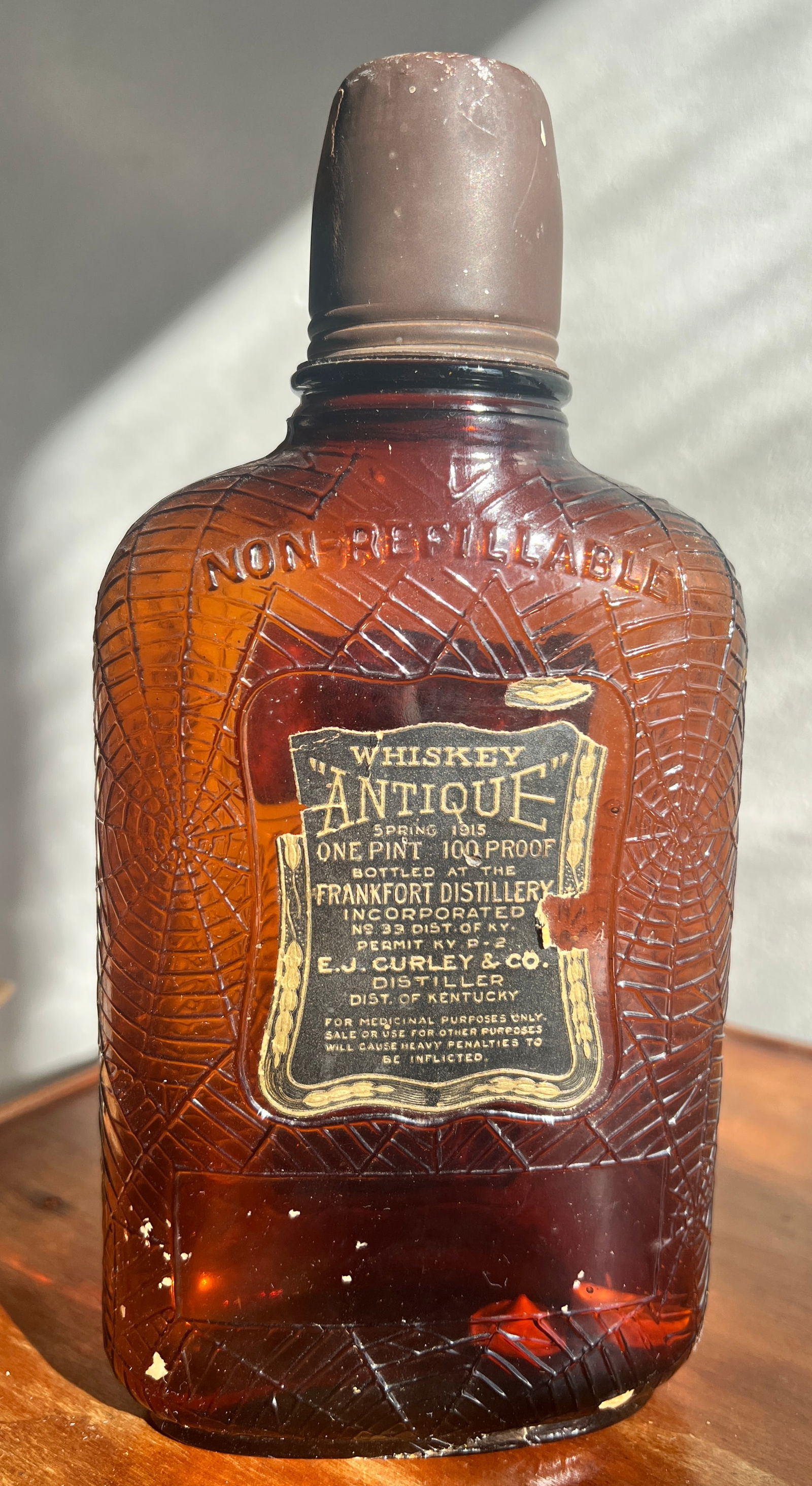 Antique Frankfort Kentucky Whiskey Bottle Spider Web Embossed: Early nice bottle w/ original cap and labels. What's to Love - Why is it embossed with spider webs.
