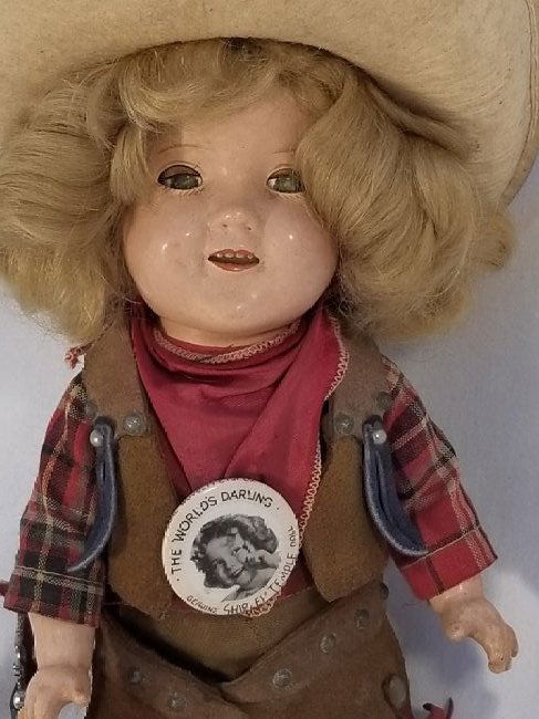 Shirley Temple Cowgirl, Complete & Original: This is a very fine example of this doll, she is all original and as far a i know complete, she is all composition, Ht Wig, Shirt, Scarf, vest, pinback, shorts, chaps, holster & Gun, socks and boots a