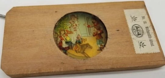 Christmas Magic Lantern Slide ~ Mechanical: Made by Ernst Plank, wooden frame with a 2-part glass slide, when the handle is moved the horse rocks, and the family celebrates around the Christmas tree. about 2 3/4 x 5 1/2 inches