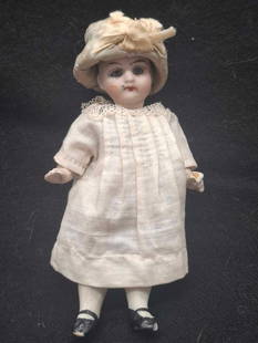 Antique Bisque Doll ~ Original clothes: a lovely little doll, she is unmarked, German or French, she is well molded and painted with glass eyes, tiny chip on her left toe appears to be mostly paint, about 5 inches tall