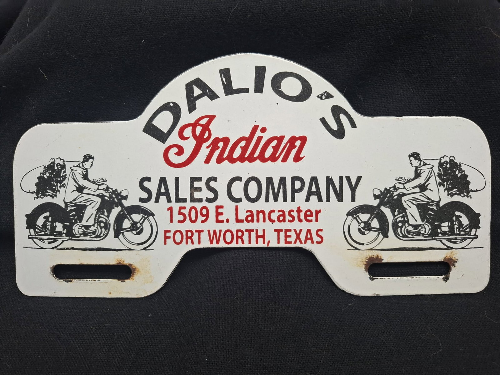 Vintage Enameled Metal License Plate Topper – Dalio’s Indian Motorcycle Sales Co., Fort Worth,: A scarce and highly collectible vintage enameled metal license plate topper advertising Dalio’s Indian Motorcycle Sales Company, located at 1509 E. Lancaster, Fort Worth, Texas. This eye-catching pi