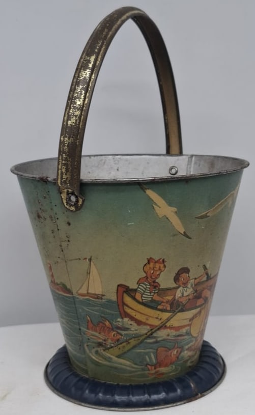 Early 20th Century Lithographed Tin Sand Pail – From Extensive European Collection: A charming and increasingly scarce early 20th century lithographed tin sand pail, exemplifying the colorful and imaginative design of classic seaside toys. This piece features vibrant period lithograp