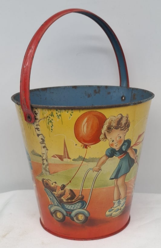 Early 20th Century Lithographed Tin Sand Pail – From Extensive European Collection: A charming and increasingly scarce early 20th century lithographed tin sand pail, exemplifying the colorful and imaginative design of classic seaside toys. This piece features vibrant period lithograp