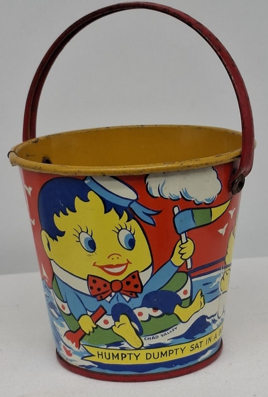 Early 20th Century Lithographed Tin Sand Pail – From Extensive European Collection: A charming and increasingly scarce early 20th century lithographed tin sand pail, exemplifying the colorful and imaginative design of classic seaside toys. This piece features vibrant period lithograp