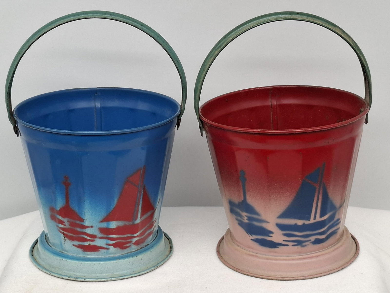 Early 20th Century Lithographed Tin Sand Pail – From Extensive European Collection: A charming and increasingly scarce early 20th century lithographed tin sand pail, exemplifying the colorful and imaginative design of classic seaside toys. This piece features vibrant period lithograp