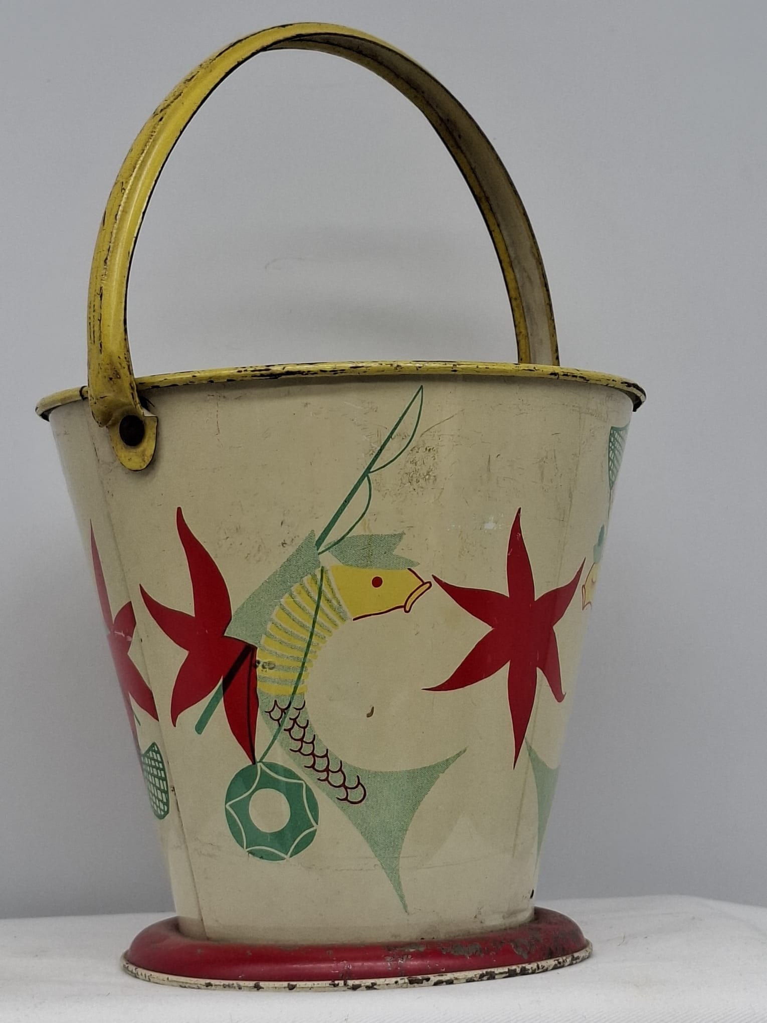 Early 20th Century Lithographed Tin Sand Pail – From Extensive European Collection: A charming and increasingly scarce early 20th century lithographed tin sand pail, exemplifying the colorful and imaginative design of classic seaside toys. This piece features vibrant period lithograp