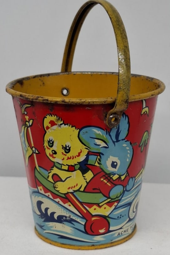 Early 20th Century Lithographed Tin Sand Pail – From Extensive European Collection: A charming and increasingly scarce early 20th century lithographed tin sand pail, exemplifying the colorful and imaginative design of classic seaside toys. This piece features vibrant period lithograp