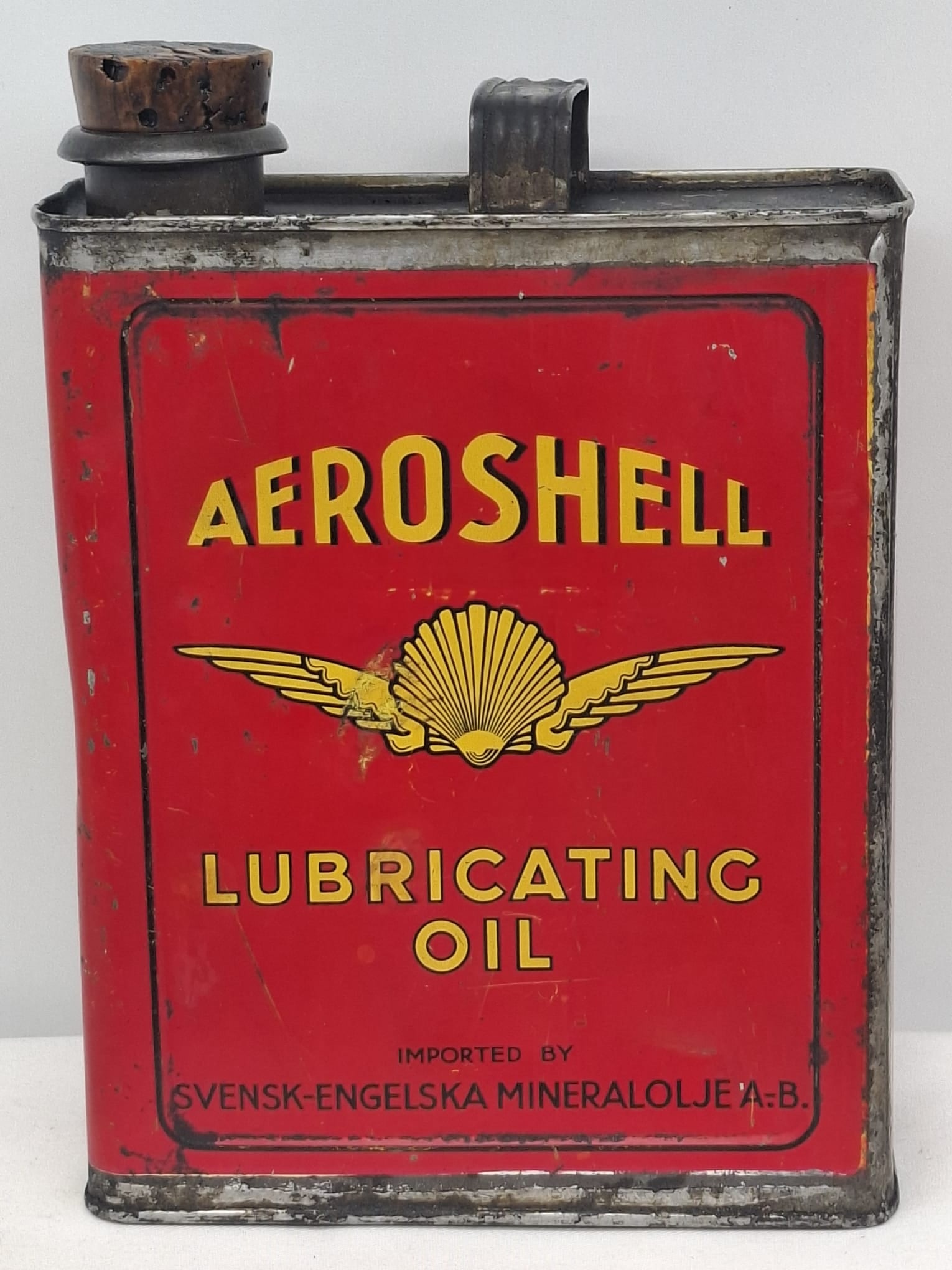 Vintage Aeroshell Oil Can (Circa 1920): Offered here is a striking and highly collectible early 20th-century Aeroshell oil can, dating to approximately 1920. This rare piece represents a formative era in aviation and high-performance
