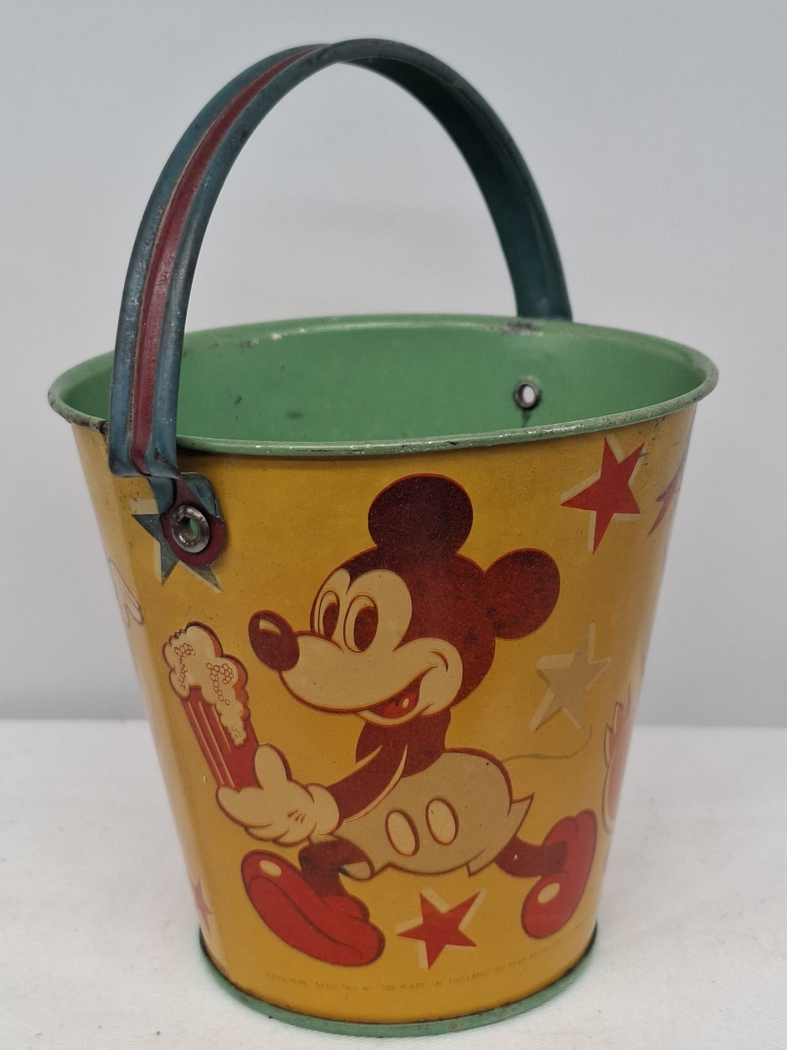 Early 20th Century Walt Disney Tin Sand Pail – From Extensive European Collection: A charming and increasingly scarce early 20th century Walt Disney tin sand pail, exemplifying the colorful and imaginative design of classic seaside toys. This piece features vibrant period lithograph