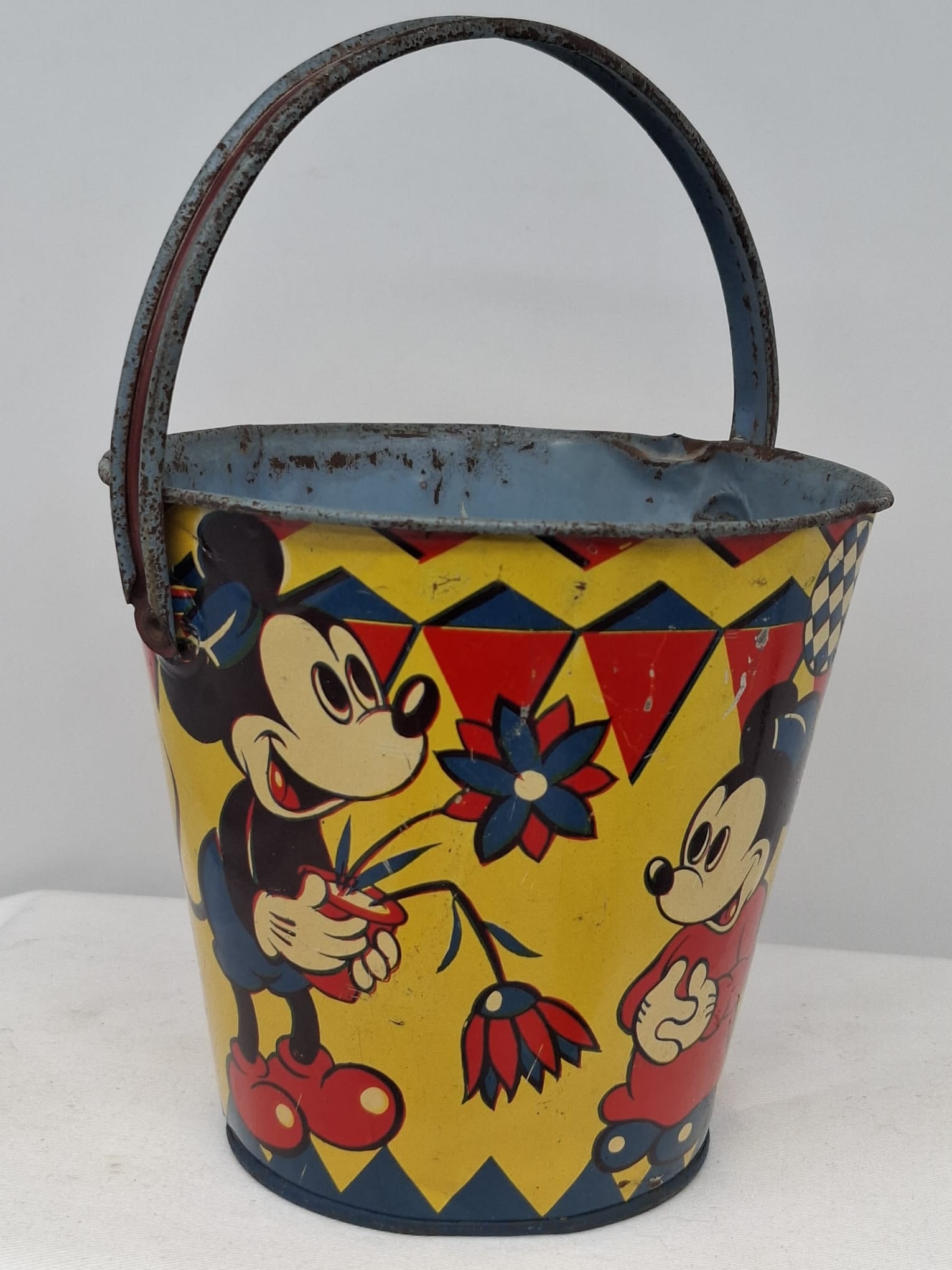 Early 20th Century Walt Disney Tin Sand Pail – From Extensive European Collection: A charming and increasingly scarce early 20th century Walt Disney tin sand pail, exemplifying the colorful and imaginative design of classic seaside toys. This piece features vibrant period lithograph