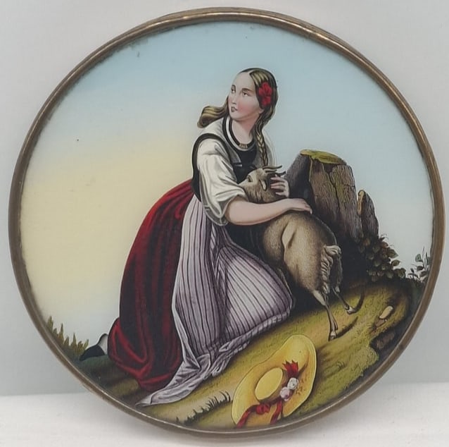 Rare Mid-19th Century Reverse Painted Glass & Dresden Trim Cardboard Box: A Rare and highly decorative mid-19th century cardboard box, notable for its unusually large size, measuring approximately 6 3/4 inches. The lid features a striking reverse-painted glass panel,