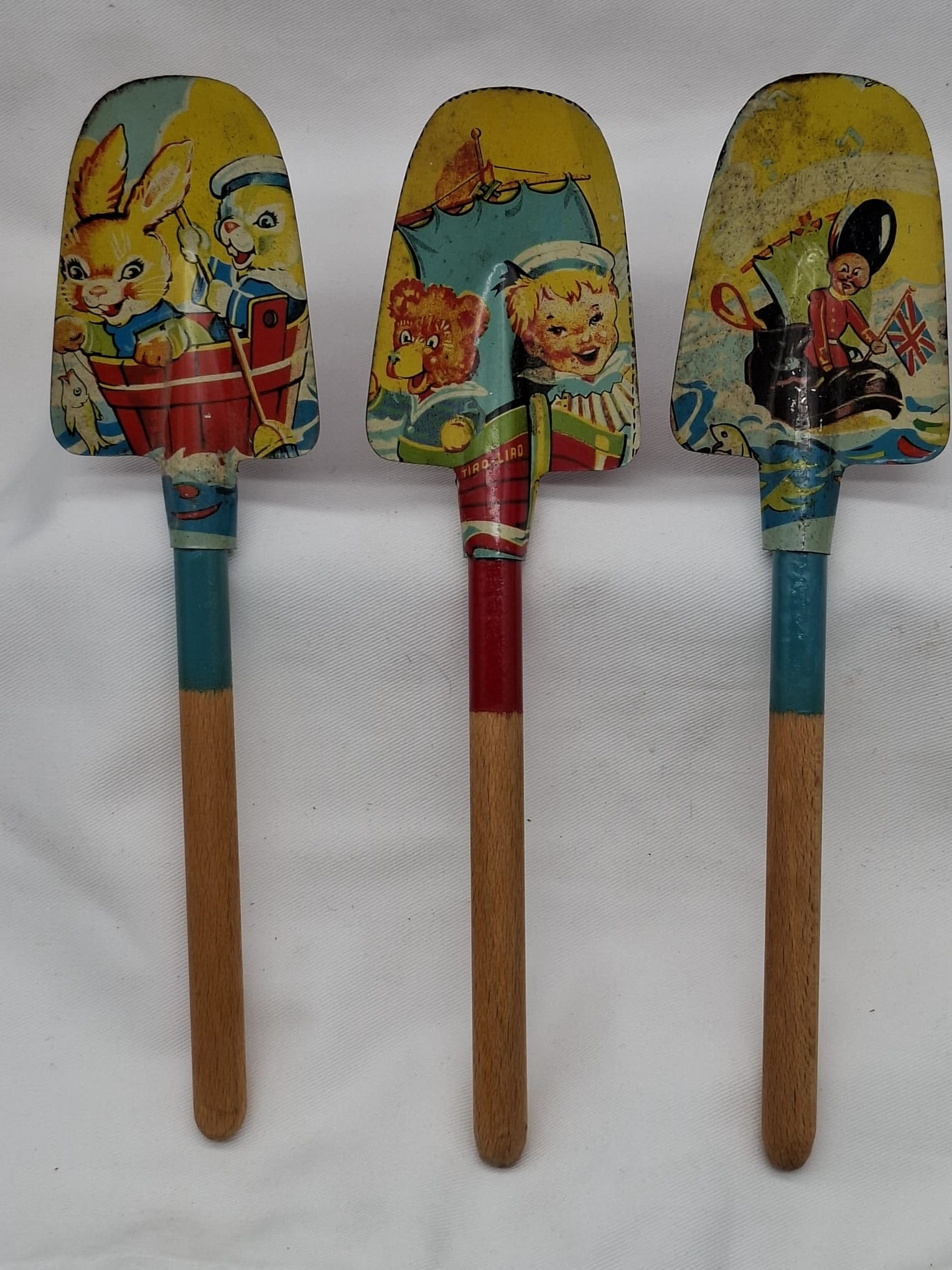Three Vintage Lithographed Tin Toy Spades with Wood Handles, Early–Mid 20th Century (1 of 4)