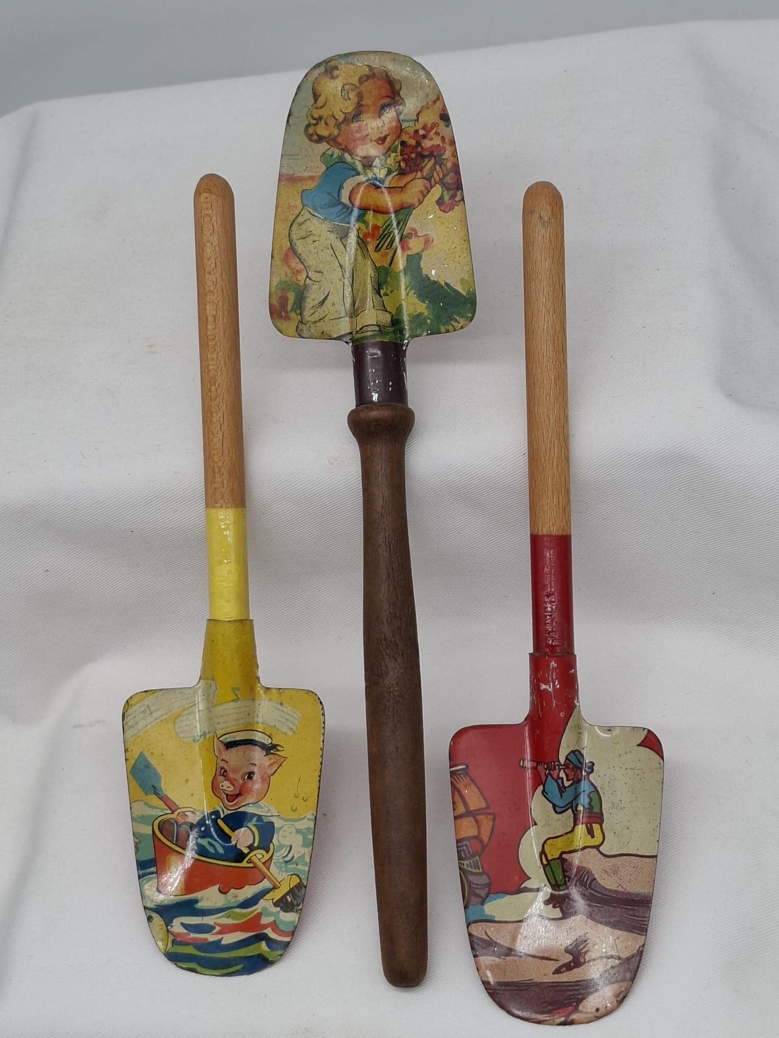 Three Vintage Lithographed Tin Toy Spades with Wood Handles, Early–Mid 20th Century (1 of 4)