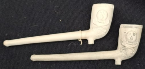 Pair of Antique English White Clay Pipes with “Death or Glory” Skull and Crossbones Motif: A striking and unusual pair of antique English white clay pipes featuring dramatic Halloween-like imagery, including skull and crossbones decoration and the evocative slogan “Death or Glory.” 