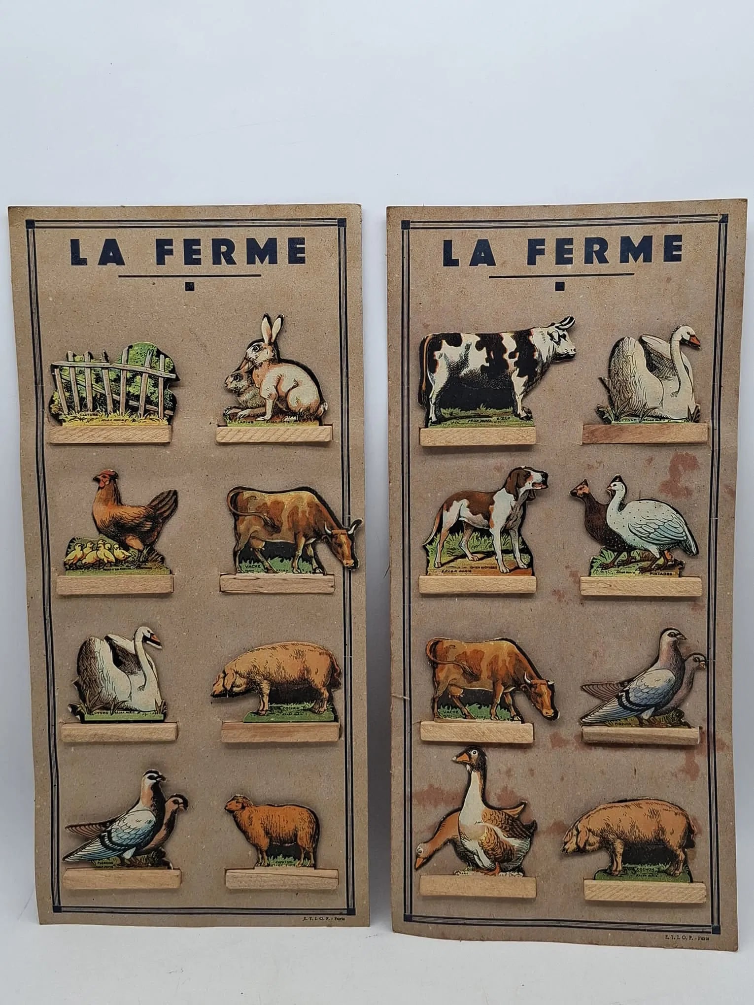 French Farmyard Die-Cut Cardboard Toy Set on Original Card, Interwar Period: Charming French farmyard toy set featuring die-cut cardboard figures mounted on wooden bases and presented on the original printed display card. Produced in Paris during the interwar period, likely