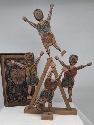Rare Complete Set of “Crandall’s Acrobats” Victorian Lithographed Clown Toy in Original: A highly unusual and complete Victorian toy set known as “Crandall’s Acrobats,” dating to the 1870s and manufactured with lithographed paper on wood. This ingenious and entertaining novelty 