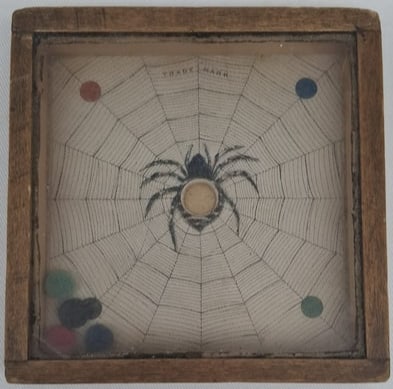 German Spider and Web Dexterity Game, Circa 1920s–1930s: Charming and unusual dexterity game featuring a spider and web motif, likely of German manufacture and dating to the 1920s or 1930s. Measuring approximately 11 x 11 cm (4.3 x 4.3 inches), this