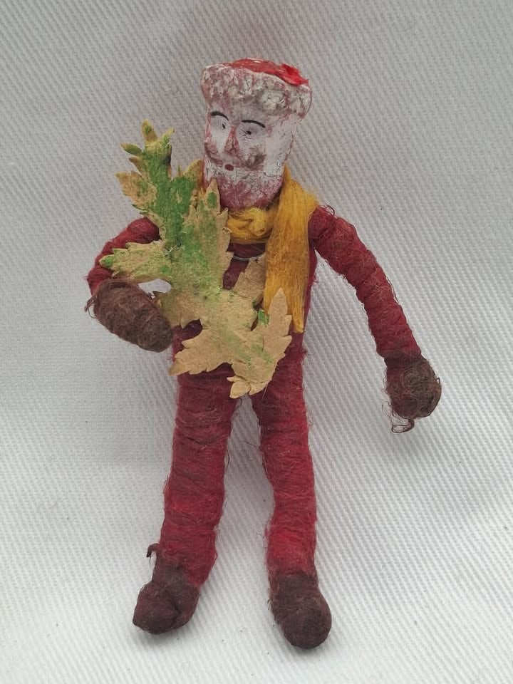 Spun Cotton Santa with Leaf: A very Unusual old spun cotton Santa with a papier mache head, h eis holding a paper leaf, about 4 inches tall
