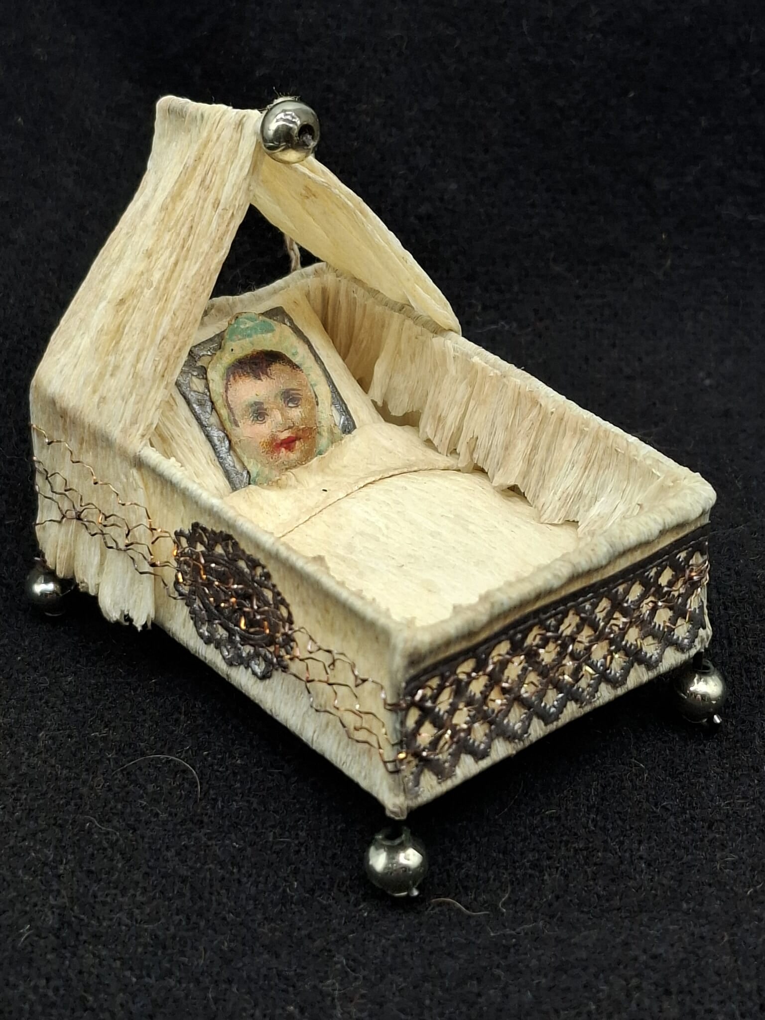 Sebnitz Crib Feather tree Ornament: This a charming old Sebnitz Ornament, very nice condition. Crepe Paper, Wire, Glass Beads.