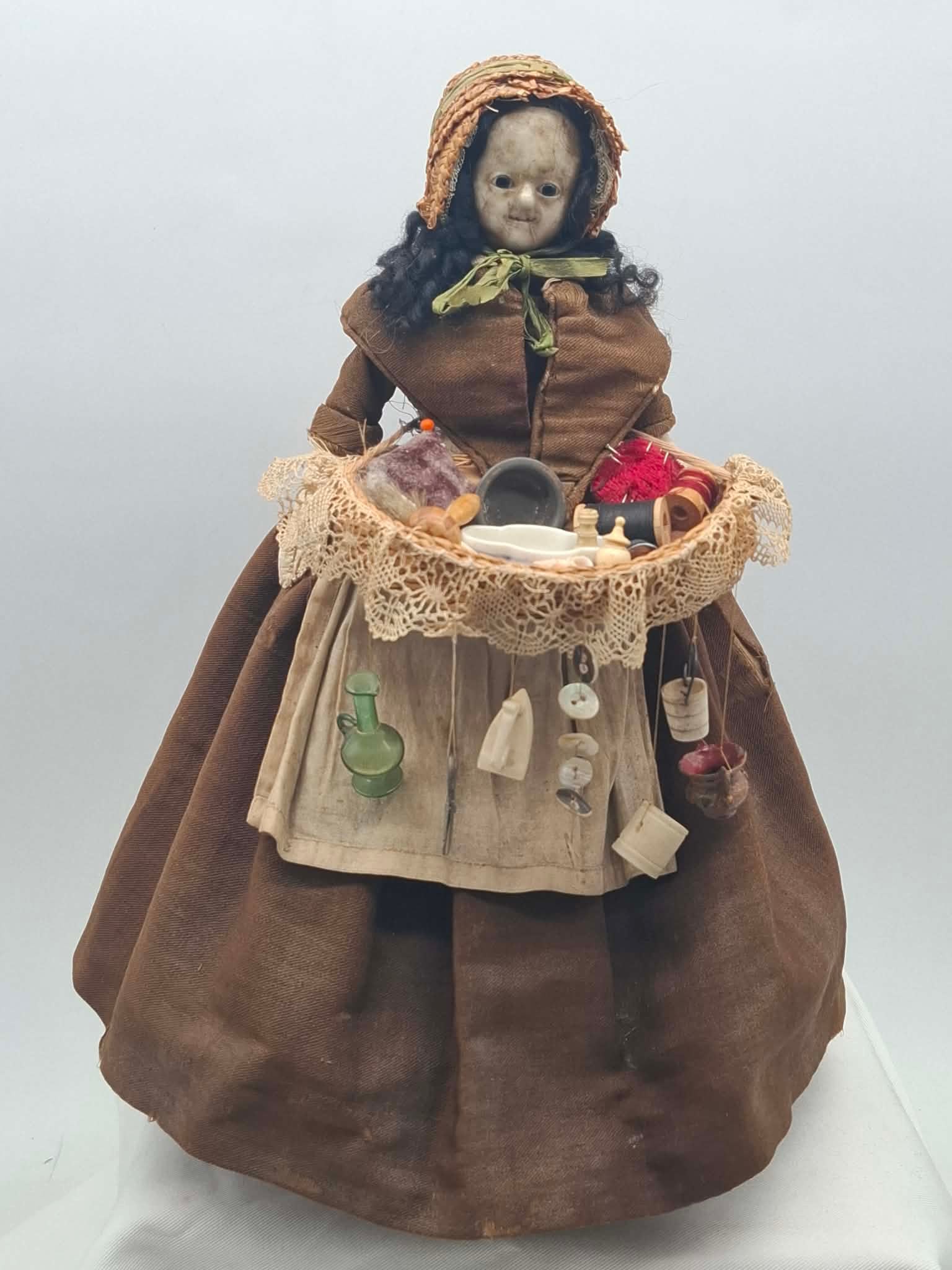 Wax Head Peddler Doll ~ circa 1840: a beautiful old wax doll, she has a wonderful old costume with underclothes, she has a wicker basket filled with miniature items made of porcelain, bone and glass, about 14 inches tall, nice curly wig