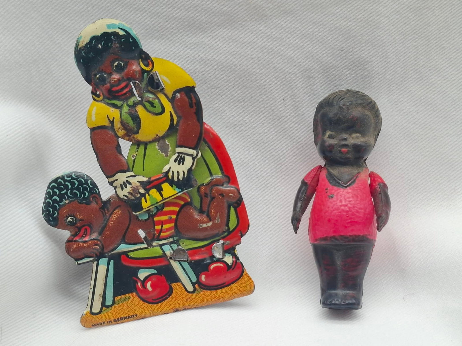 Penny Toy Clicker & Celluloid Doll: A very curt clicker toy, when you click it, she scrubs the boy with a brush also includes a small celluloid doll, Black Americana,
