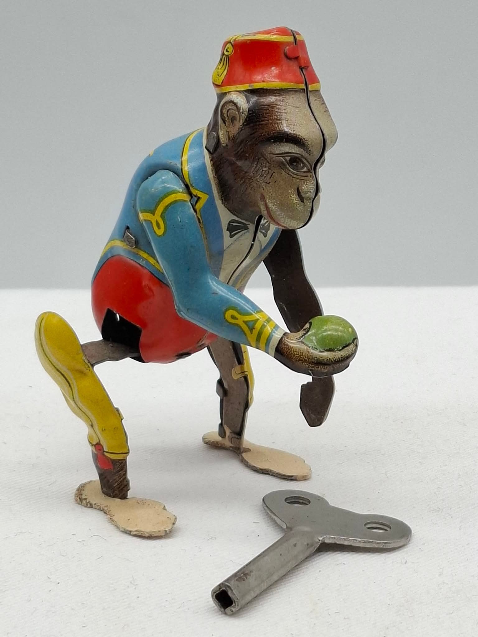 US Zone Germany Monkey: this is a charming little monkey wind up toy, he is in good working condition with a key,
