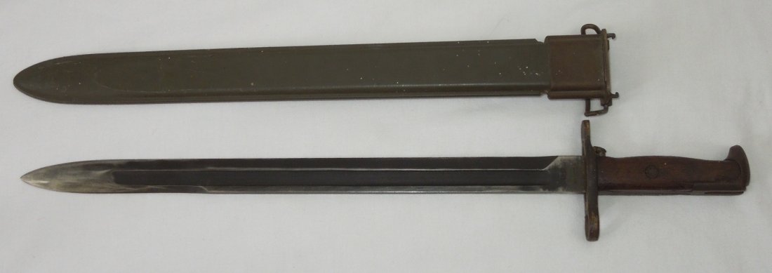 US Military RIA 1919 Bayonet & Scabbard: US 1919 Long rifle bayonet made by Rock Island Arsenal, in a post WWI Flaming Bomb scabbard.