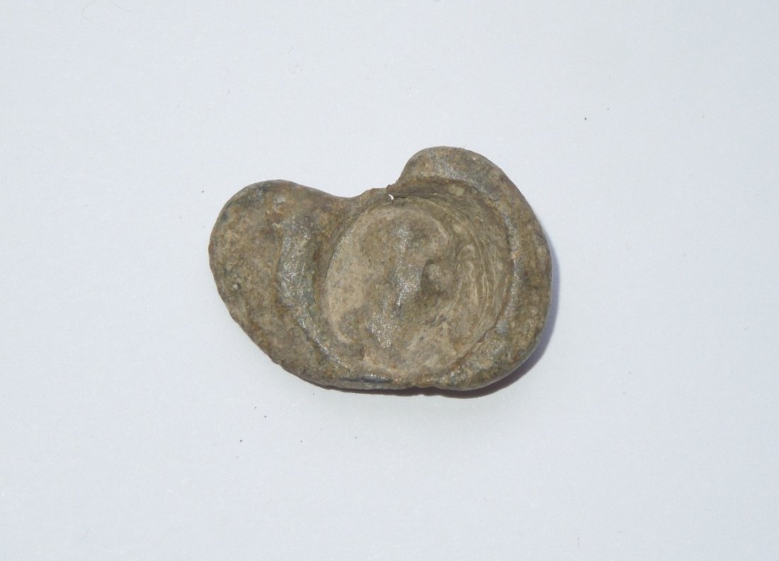 Ancient Roman Bullae Lead Seal Artifact: Ancient Roman Bullae Lead Seal Artifact. It appears the seal had been done with a signet ring. This item came from a long time collector of ancient artifacts. It is being sold as is based on the colle
