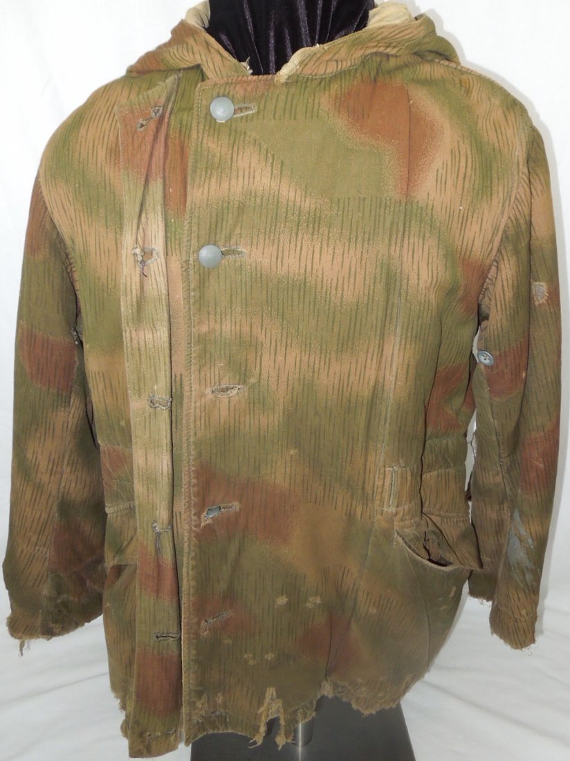 WWII German Winter Splinter Camo Reversable Parka: Original WWII German Winter Splinter camouflage parka coat. This was a very well used piece with several tears, holes, and some gray paint staining on one sleeve. This was obtained via the estate of a