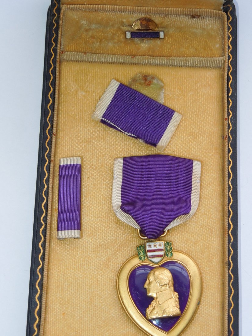 Unnamed WWII US Military Purple Heart Medal Set in Box: Original WWII slot brooch US Purple Heart Medal issued for wounds received in action. Set consists of medal, ribbon bar, lapel pin, ribbon piece, and the titled coffin case. The medal is not engraved 