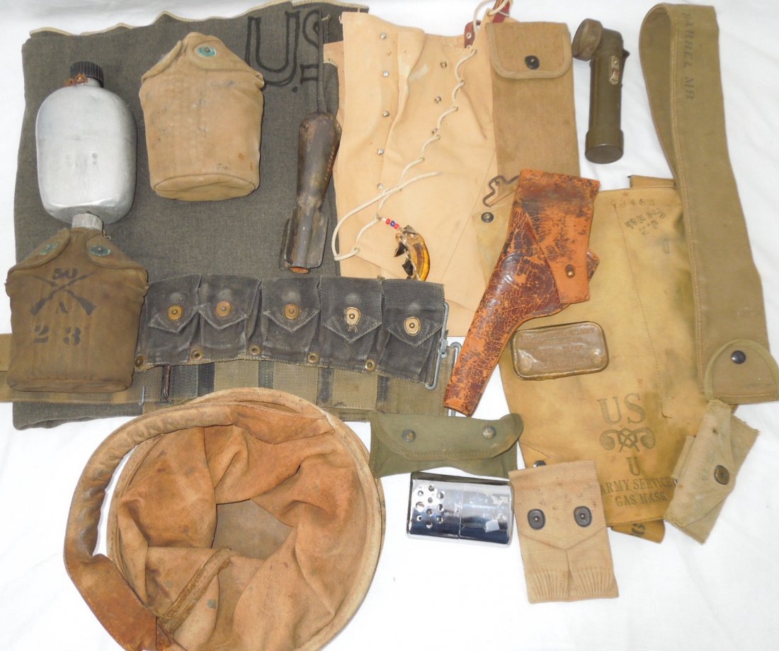 WWI – WWII US Military Field Gear Canteens Holster Belt: Lot of items to include early US Military blanket, Mills Colt .45 magazine pouch, 1909 RIA Holster, black dyed M-1 Garand Ammo belt, Mexican Army Canteen, 2x WWI Canteens (one with Infantry unit marki