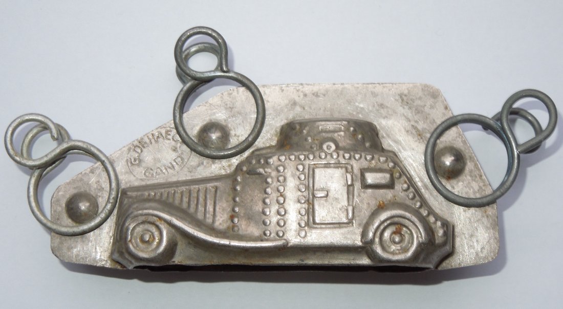 Pre WWII German Military Armored Chocolate Mold Dehaeck: Original WWI - 1930s era German tin style chocolate mold depicting an armored vehicle car. G. Dehaeck and Gand are stamped onto it.