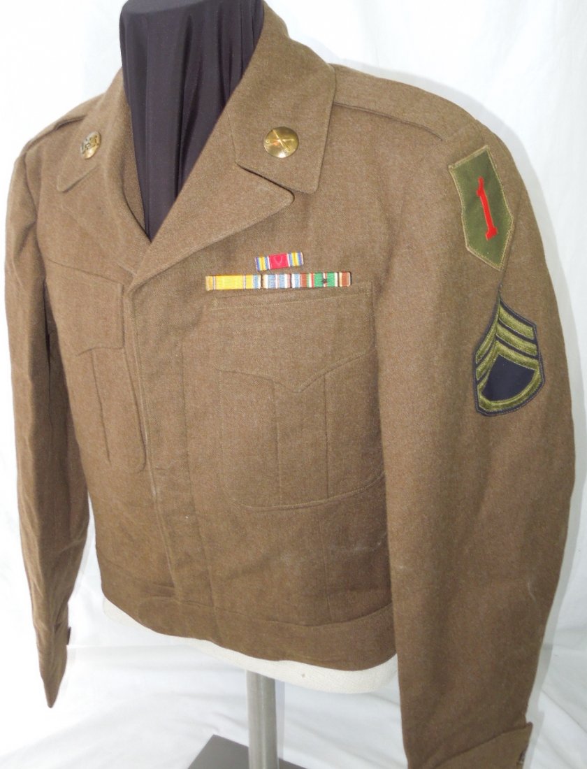 WWII US Army 1st Infantry Division Ike Uniform Jacket: US Army WWII Occupation era Ike jacket with a German made 1st Infantry Division Big Red One patch, pin on ribbon bars, Staff Sergeant Rank, and Artillery collar insignia. No name but has a laundry mar
