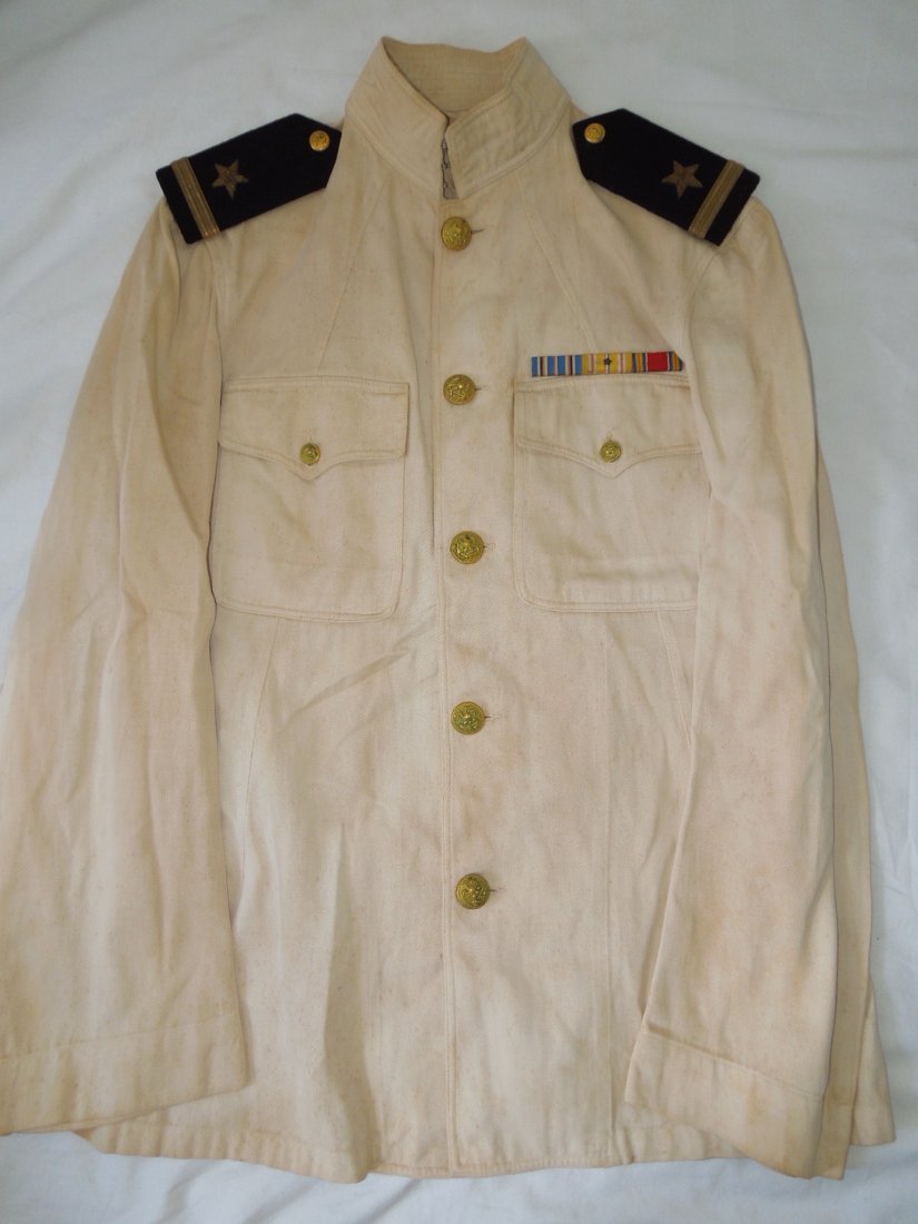 WWII US Navy Ensign Pacific White Choker Uniform: WWII US Navy choker white uniform jacket, not named and no tag, with Ensign shoulder boards in bullion and a wide Navy style ribbon bar showing Pacific Service. White is soiled from age.
