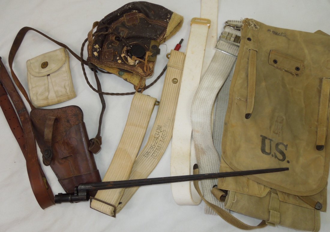 WWII - 50s Military Field Gear Holster Bayonet Lot: WWII - 50s field gear lot including Navy belts, field pack, a spike type bayonet, Boyt 1943 marked shoulder holster, Hunter brand marked sling, a relic condition B-6 AAF helmet and ammo pouch. Most it