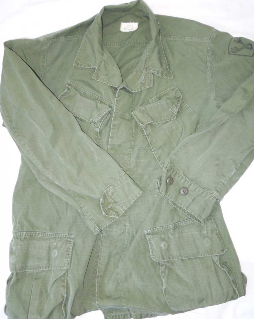 Vietnam US 196th Light Infantry LR Fatigue Shirt: Vietnam era slant pocket Large Regular jungle jacket with a stamped 196th Light Infantry insignia. Well worn with at least one cuff button missing.