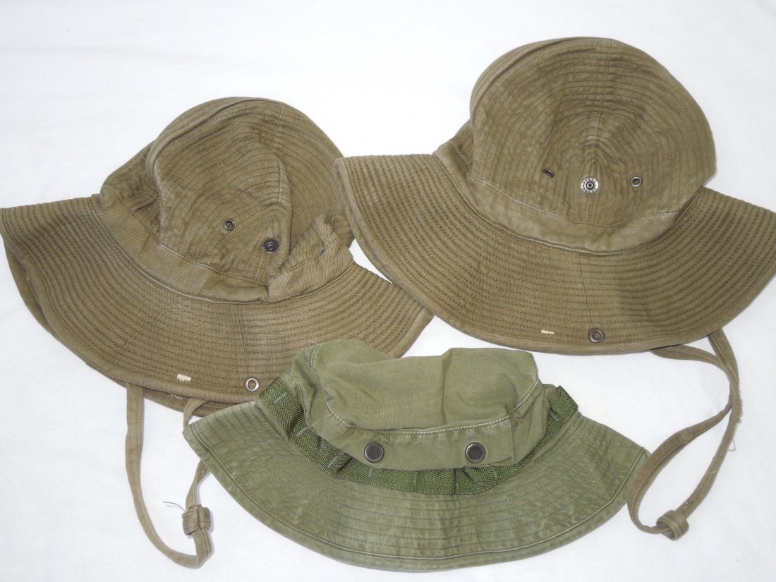 French Indochina Vietnam Planters Hats And Pilot Boonie: Lot of three caps: Two French Indochina Planter Hats made in Orleans, France, both size 55. The third is a Vietnam helicopter pilot's Boonie hat dated 1972.
