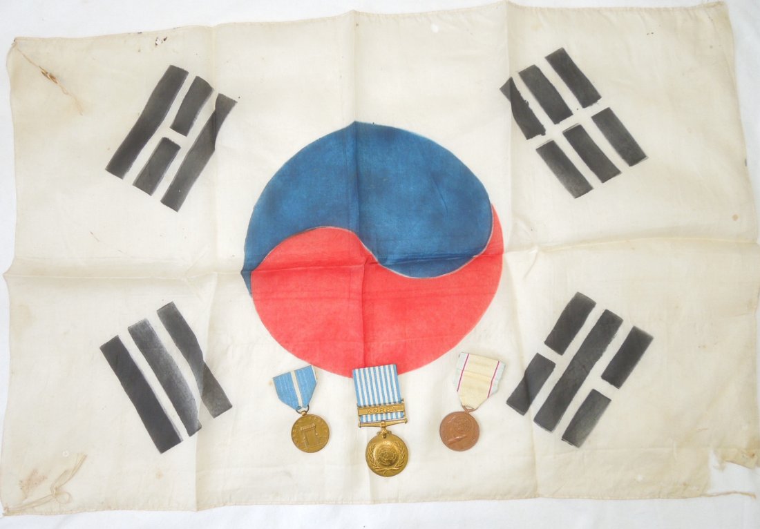 Korean War South Korea Silk Flag and Medals: Korean War era South Korean silk flag brought back by an unknown 7th Infantry Division US vet who served at Inchon. It is in fair condition with some tearing near the corners and edges. Comes with per