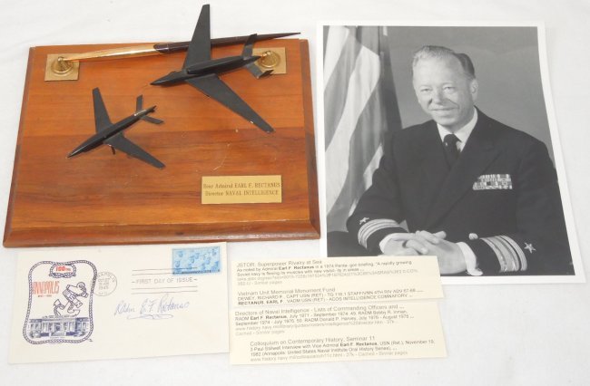 Rear Admiral Rectanus Signed FDC Photo Desk Plaque Lot: USN Navy Rear Admiral Earl F. Rectanus Signed 1945 Postmark First Day Cover (FDC), 8 x 10 inches Unsigned Photo and Desk / Pen / Planes Presentation Plaque and a short biography Lot. The presentation 