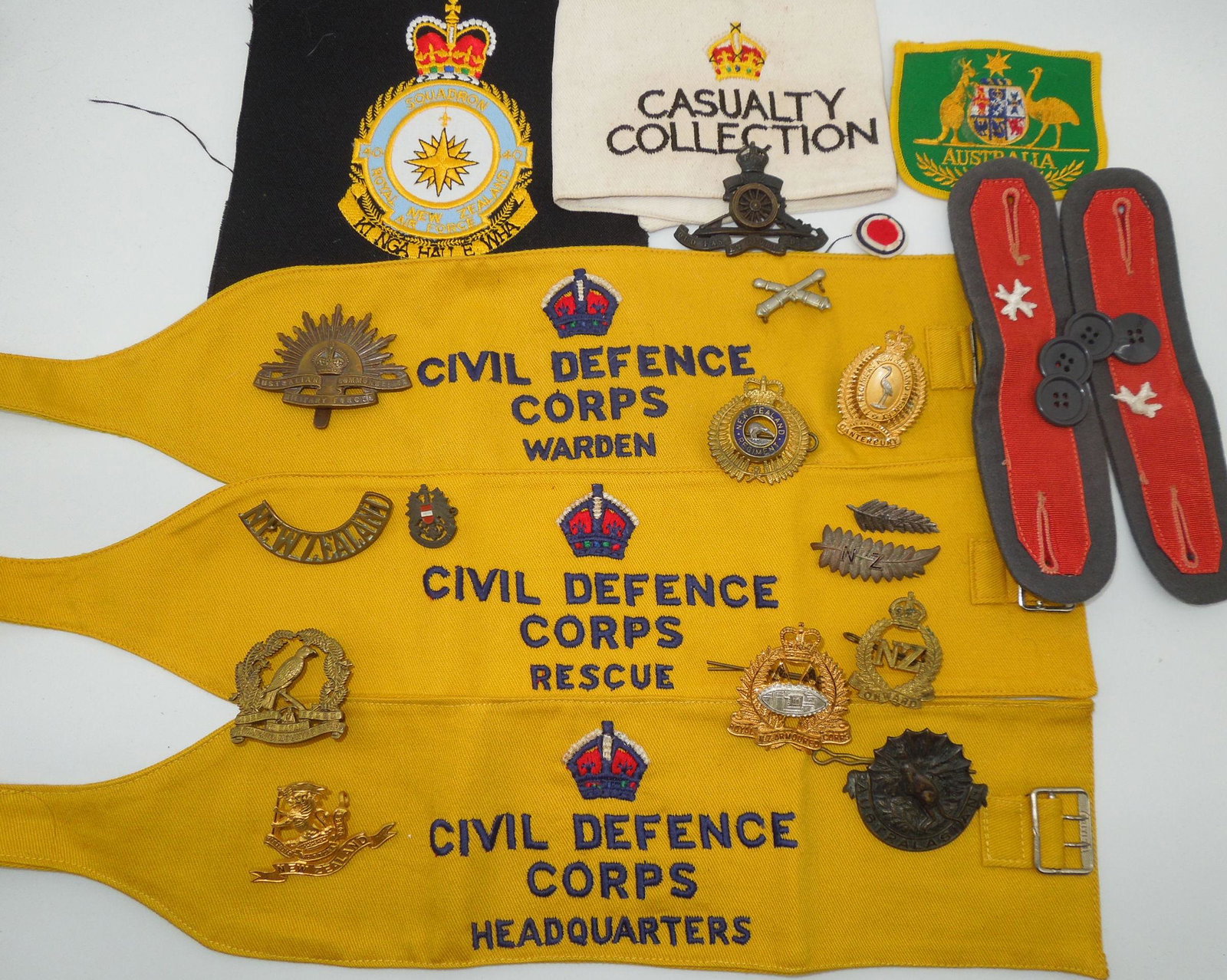 WWII & After Australia & New Zealand Military Badges Armbands Pins: Vintage lot of Australia and New Zealand Civil Defense Armbands, pins, badges, patches, etc. Good condition with wear from use.