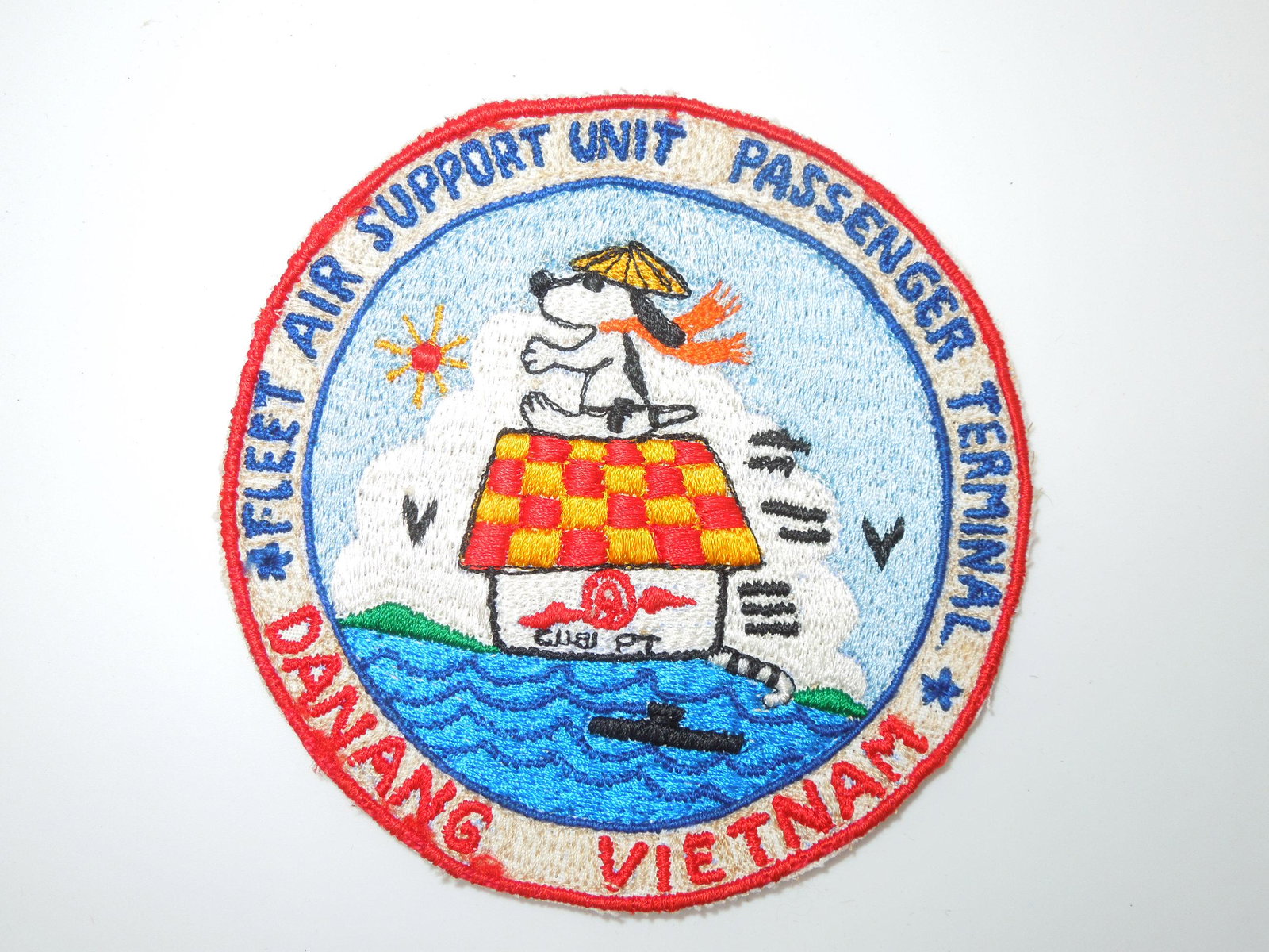 Vietnam War Era Danang Snoopy Theater Made Patch: Pacific Theater made Fleet Air Support Unit Passenger Terminal Danang Vietnam patch. Good condition with wear from age.