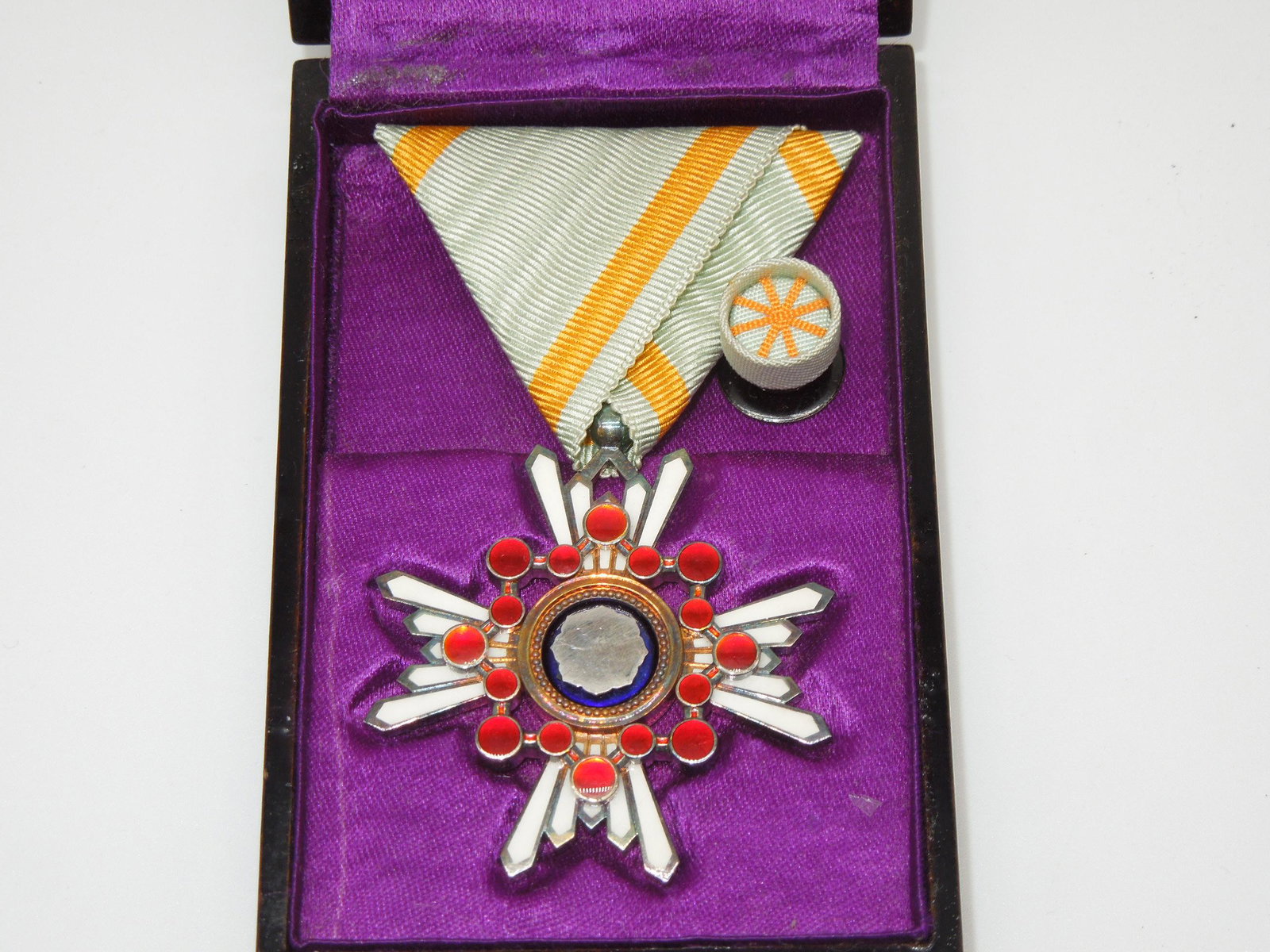Japanese Order of the Sacred Treasure 5th Class Medal Badge & Rosette Pin w/ Case of Issue: Japanese Order Of The Sacred Treasure Medal and Rosette Pin, 5th Class Badge With Case Of Issue. The Order of the Sacred Treasure, established in January of 1888, was awarded to either military or civ