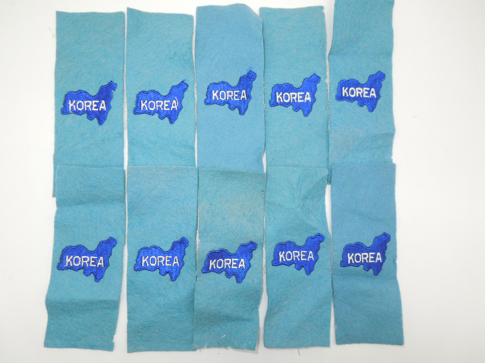 Korean War US Army Blue Uniform Epaulette Tab Patches Lot 10 Pairs: Original Korean War unused tabs as shown. Some have wrinkling or moth tracking on them.