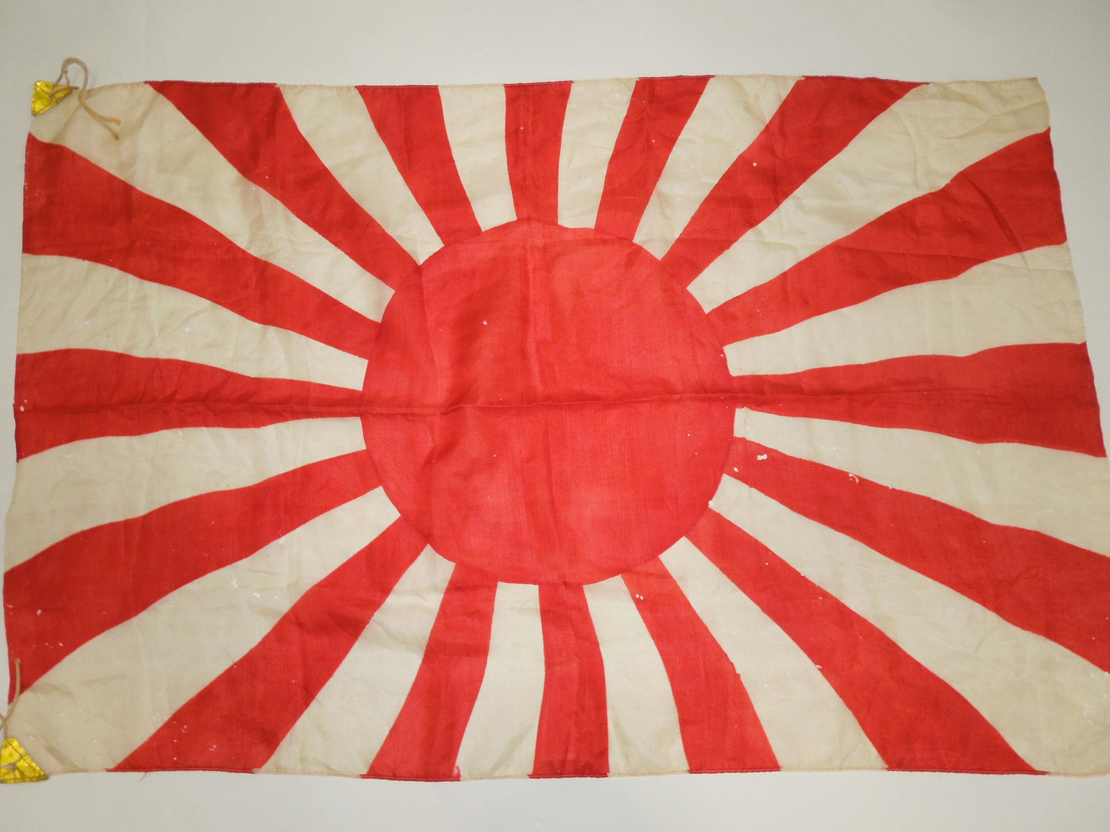 WWII Era Japanese Japan National Imperial Navy Rising Sun Silk Flag #1: Japanese National Imperial Navy Rising Sun Silk Flag. Approximate size of the flag is 24 x 36 inches. Rope on both corners. Condition of the flag show signs of wear with small holes throughout. Good e