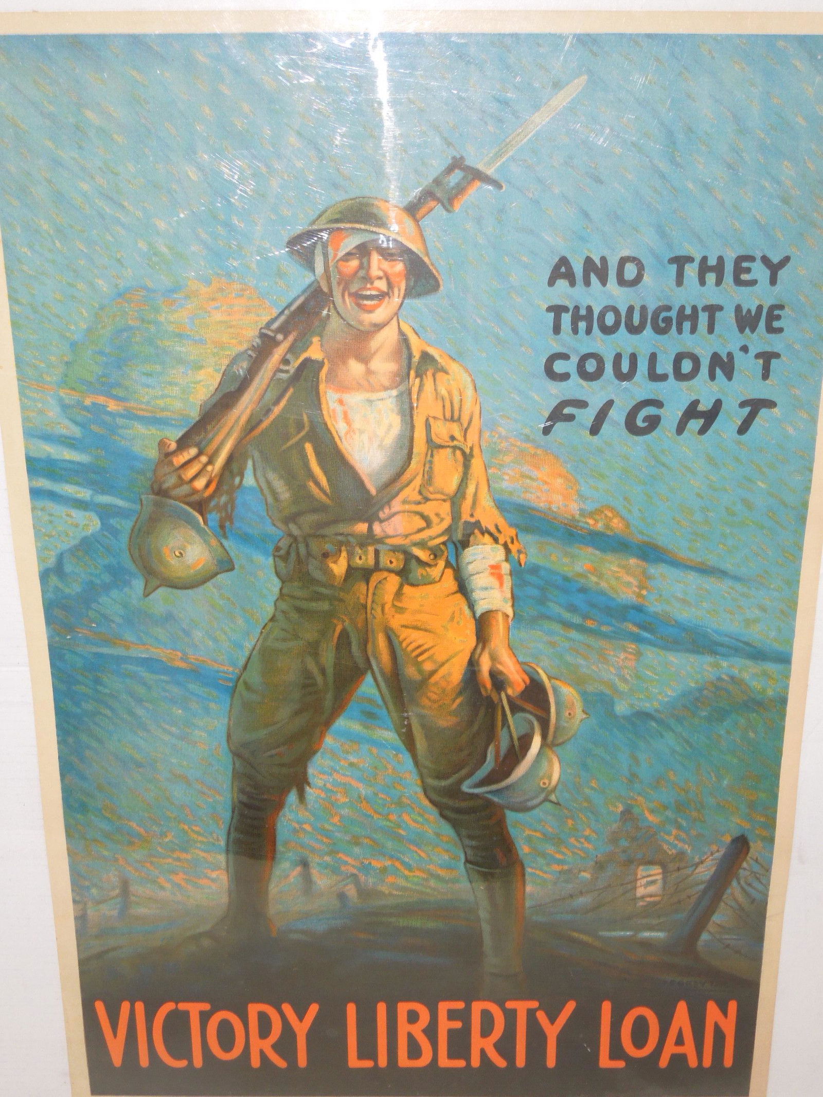 WWI Wounded Soldier Victory Liberty Loan Propaganda Poster: WWI American propaganda poster featuring a color illustration of a wounded yet smiling wounded soldier on the battlefield. His uniform sleeves are tattered, and he is bloodied and bandaged; he wears a