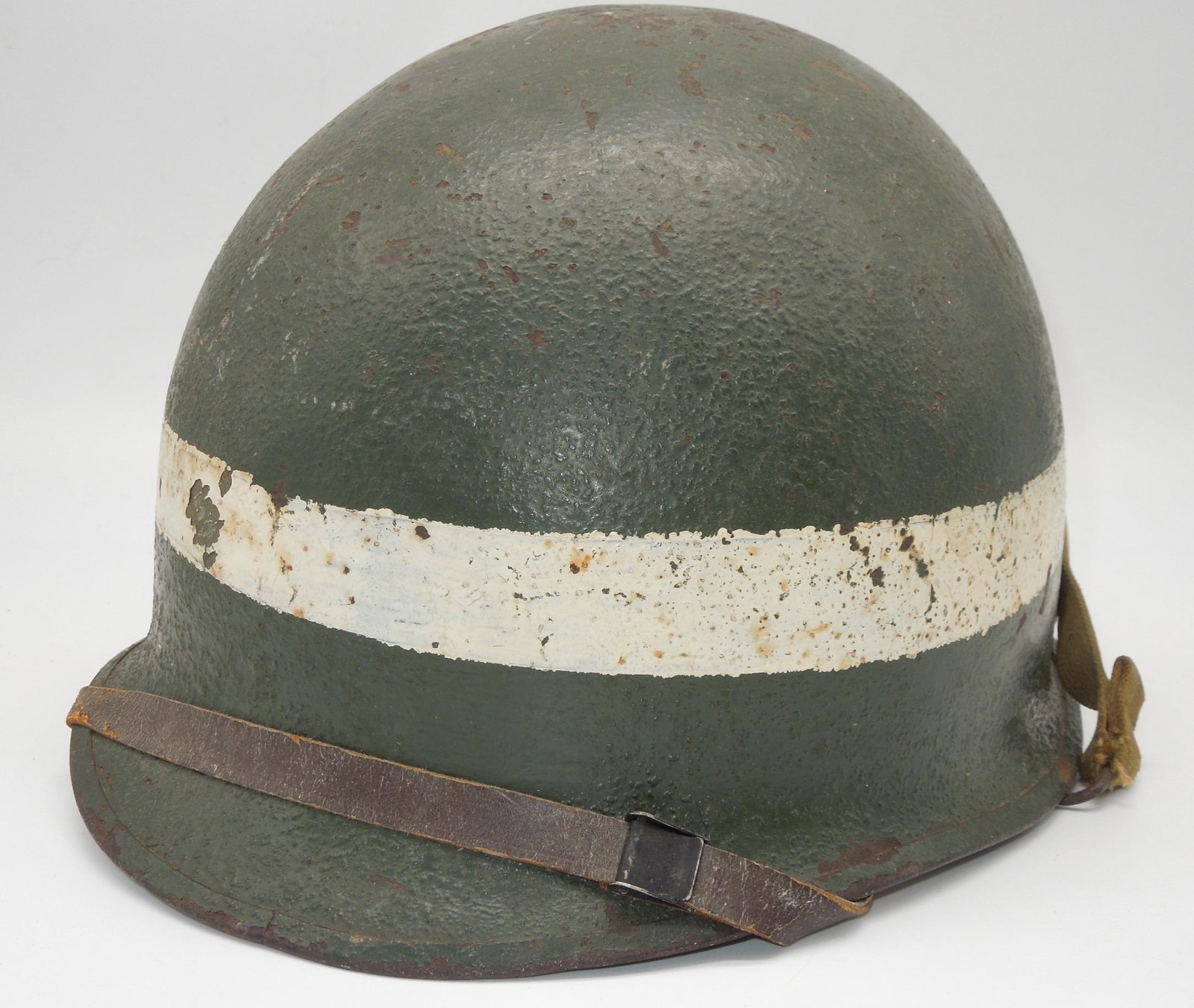 WWII Painted Officer M-1 Helmet, Liner, Chinstrap: Nice painted M-1 Helmet and liner. Named to "Lt. Nemeth" in the webbing. Front seam, Swivel Bail, Westinghouse Liner.