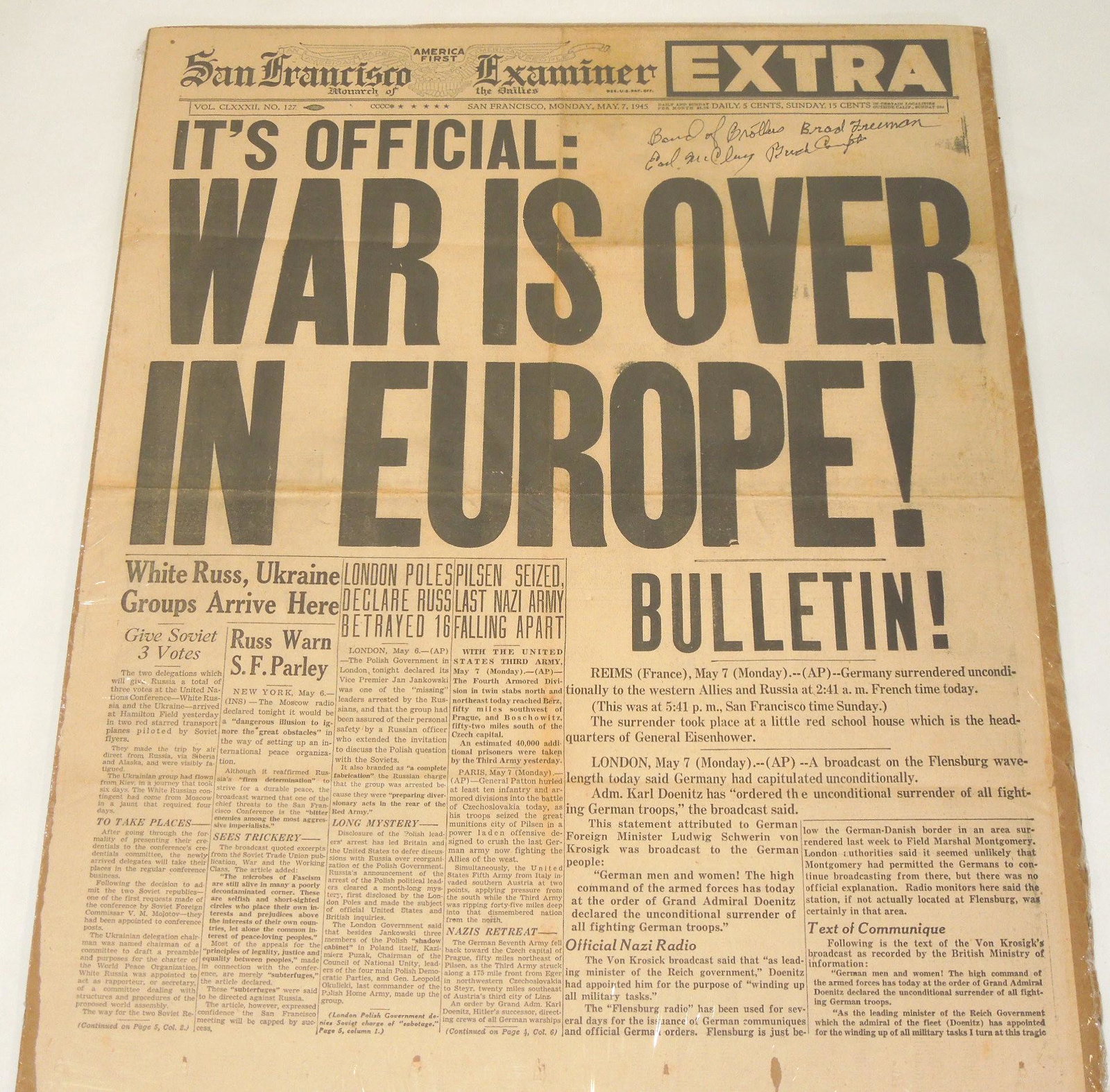 May 7, 1945 WAR IS OVER Newespaper Signed By Two 101st Airborne Band of Brothers: May 7, 1945 War Over in Europe, San Francisco Examiner newspaper, with two hand signatures of 101st Airborne Band of Brothers- Earl McLung, and Brad Freeman. Good condition with folds. The paper has b