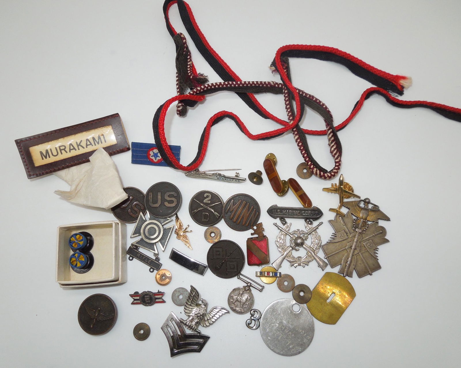 Misc. WWI - Vietnam US, British, Japanese Pins & Insignia Lot: Large lot of items such as WWI US Collar discs, sterling badges, mini British medal, Japanese Army medal, USMC badge, WWI aviation collar disc, Japanese American uniform name tag, John F. Kennedy PT B