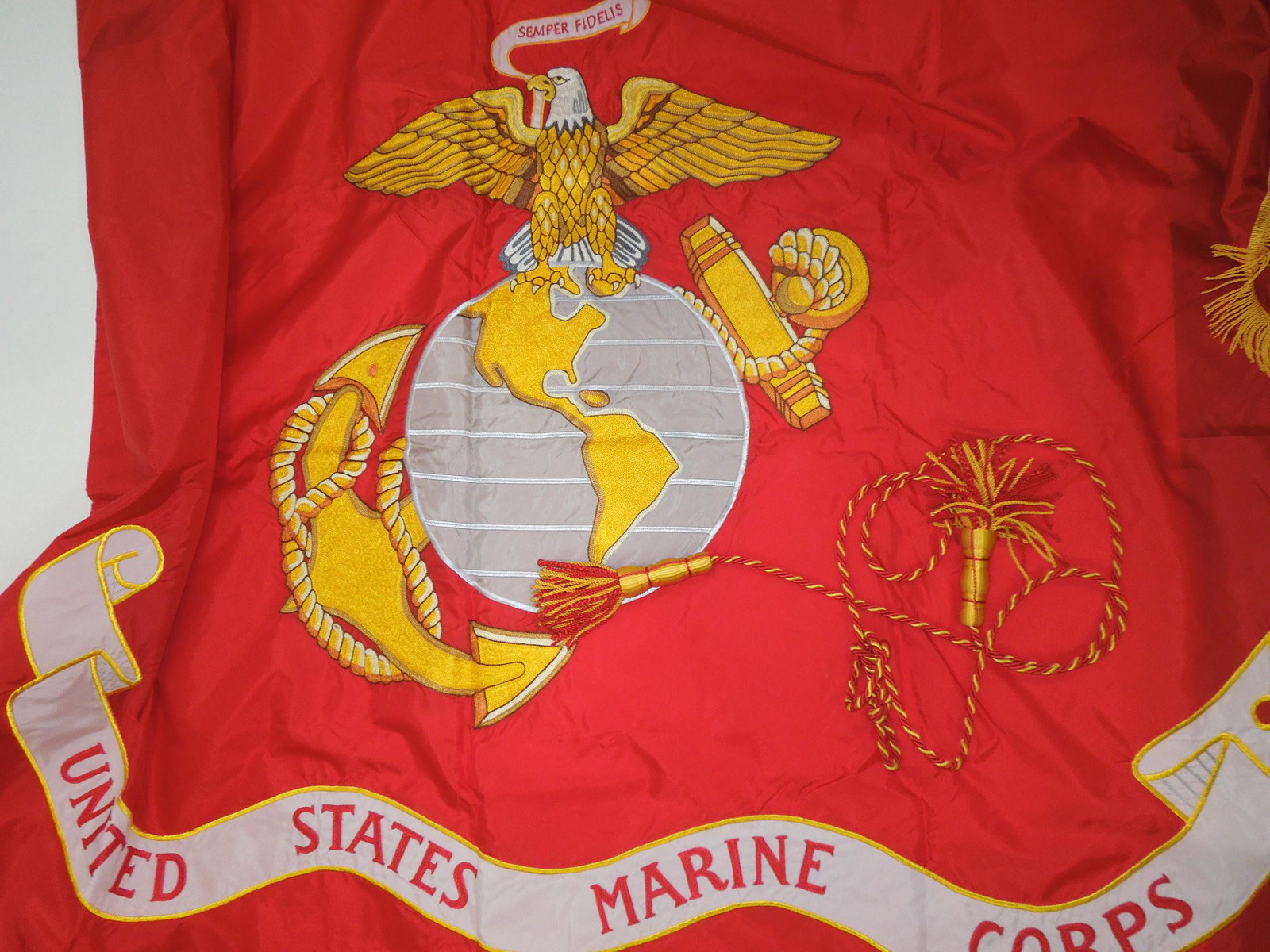 1985 US Tagged Large Organizational USMC Marine Corps Flag: Original 1985 dated and tagged flag and tassel, measuring approximately 5 feet 6 inches, by 4 feet 4 inches. Excellent condition.